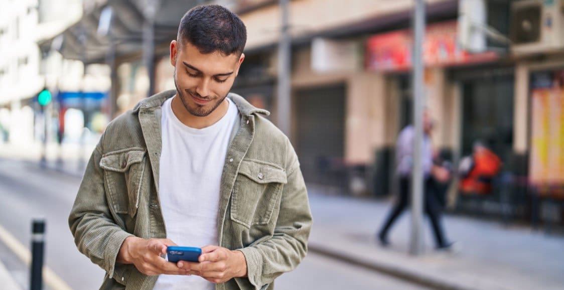 Guy-on-phone-walking-the-street-using-Chatbot